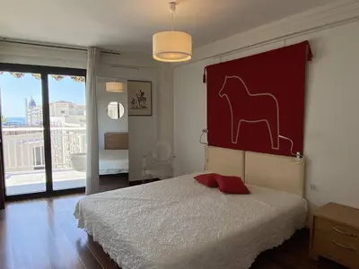 a bedroom with a bed with a horse painting on the wall at Cannes proche Croisette - Appartement 3 Pièces vue mer terrasse Helv7 in Cannes