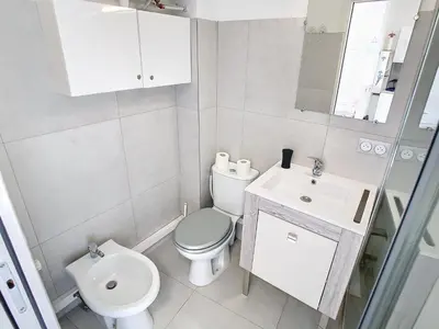 a white bathroom with a toilet and a sink at Lovely, modern studio with sea view 117 in Cannes