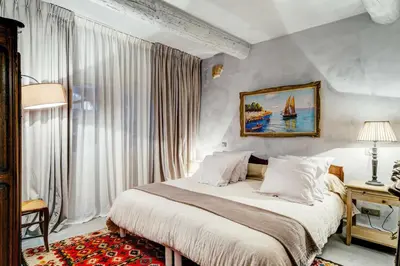 a bedroom with a bed and a large window at Charming studio In the heart of Cannes in Cannes