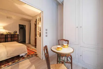 a room with a table and a bed and a bedroom at Charming studio In the heart of Cannes in Cannes