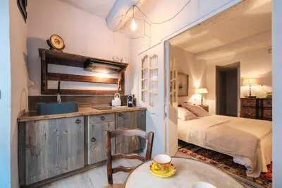 a bathroom with a sink and a bed in a room at Charming studio In the heart of Cannes in Cannes