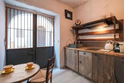 a kitchen with a table and a table and a door at Charming studio In the heart of Cannes in Cannes