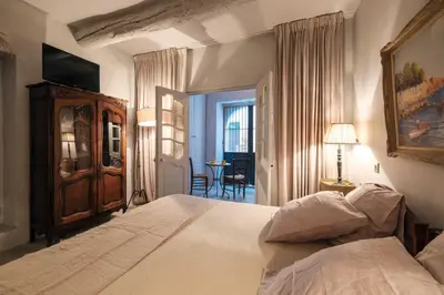 a bedroom with a bed and a table in a room at Charming studio In the heart of Cannes in Cannes