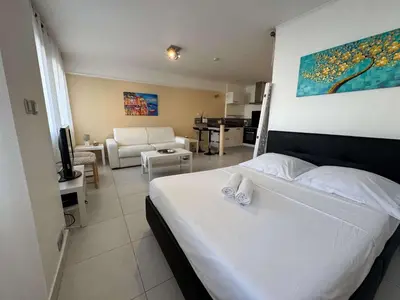 a bedroom with a bed and a living room at B075-Studio agréable centre Cannes in Cannes