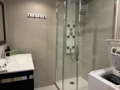 a bathroom with a glass shower and a sink at B075-Studio agréable centre Cannes in Cannes