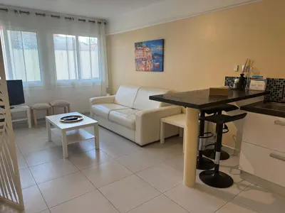 a kitchen and living room with a couch and a table at B075-Studio agréable centre Cannes in Cannes