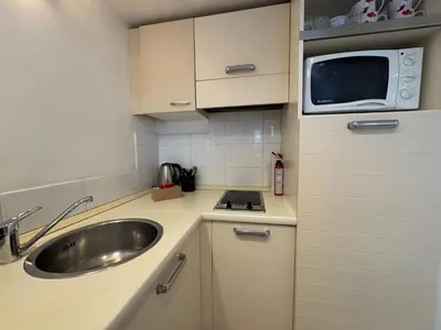 a small kitchen with a sink and a microwave at A079 Appartement confortable sur Carnot -1 chambre in Cannes