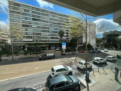 a parking lot with cars parked in front of a building at A079 Appartement confortable sur Carnot -1 chambre in Cannes