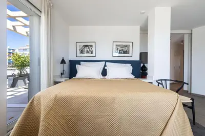 a bedroom with a large bed with a yellow blanket at Outstanding Rooftop Cannes 4 bed Apt Sea Views in Cannes