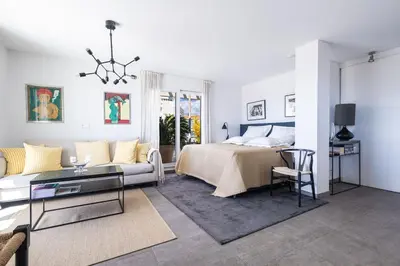 a living room with a bed and a couch at Outstanding Rooftop Cannes 4 bed Apt Sea Views in Cannes