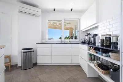 a white kitchen with a sink and a window at Outstanding Rooftop Cannes 4 bed Apt Sea Views in Cannes