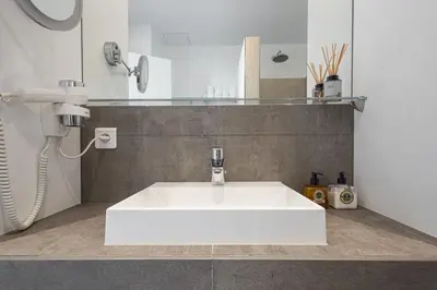 a bathroom with a white sink and a phone at Outstanding Rooftop Cannes 4 bed Apt Sea Views in Cannes