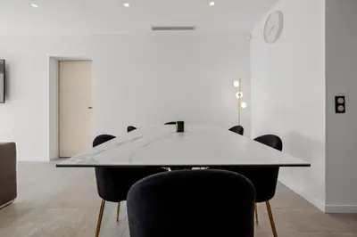 a conference room with a table and chairs at Havre de Paix avec Villa Prestige Cannes Luxe, Piscine Chauffée, Alarme, Caméras Parking privée in Le Cannet