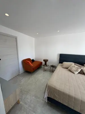 a bedroom with a bed and a chair at Havre de Paix avec Villa Prestige Cannes Luxe, Piscine Chauffée, Alarme, Caméras Parking privée in Le Cannet