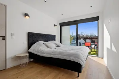 a bedroom with a large bed and a large window at Havre de Paix avec Villa Prestige Cannes Luxe, Piscine Chauffée, Alarme, Caméras Parking privée in Le Cannet