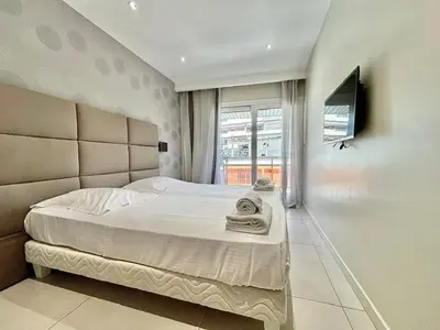 a bedroom with a large bed and a television at Cannes appartement 3 chambres - 8D in Cannes