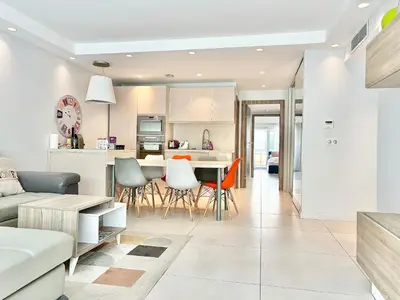 a kitchen and living room with a table and chairs at Cannes appartement 3 chambres - 8D in Cannes
