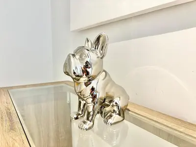 a silver statue of a dog sitting on a glass table at Cannes appartement 3 chambres - 8D in Cannes
