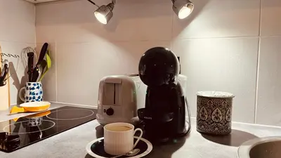 a coffee maker sitting on a counter in a kitchen at CANNES Appartement - terrasse, jardin prive, parking, piscine, climatisation in Cannes