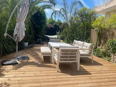 a patio with a table and chairs and an umbrella at Cannes appartement 1 chambre - Victoriam in Cannes