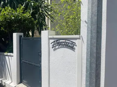 a wall with a gate with a spider painted on it at Cannes appartement 1 chambre - Victoriam in Cannes
