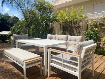 a white table and chairs on a wooden deck at Cannes appartement 1 chambre - Victoriam in Cannes
