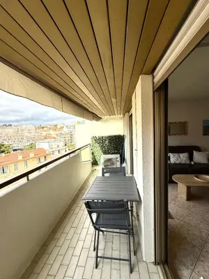 a patio with a table and chairs on a balcony at T2 avec terrasse, Gare Cannes & Croisette à pied in Cannes