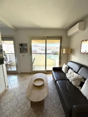 a living room with a couch and a coffee table at T2 avec terrasse, Gare Cannes & Croisette à pied in Cannes