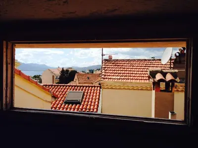 a view from a window of roofs of buildings at CANNES CENTRE CHARMANT 2 ROOMS+MEZZANIN in Cannes