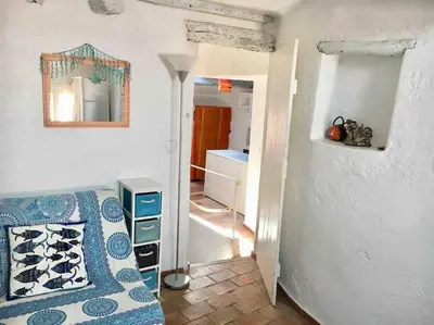 a bedroom with a bed and a mirror on the wall at CANNES CENTRE CHARMANT 2 ROOMS+MEZZANIN in Cannes