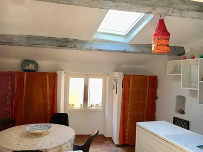 a kitchen with a table and a window at CANNES CENTRE CHARMANT 2 ROOMS+MEZZANIN in Cannes
