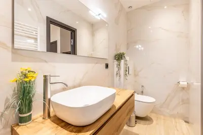 a white bathroom with a sink and a toilet at Bliss Triplex - Hyper Centre - Sauna - BBQ - Jacuzzi - LRACANNES in Cannes