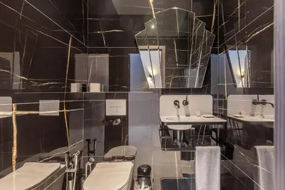 a bathroom with two sinks and two toilets at Bliss Triplex - Hyper Centre - Sauna - BBQ - Jacuzzi - LRACANNES in Cannes