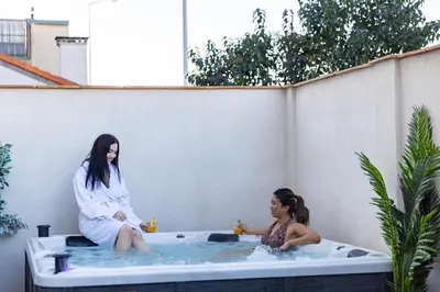 two women sitting in a jacuzzi tub at Bliss Triplex - Hyper Centre - Sauna - BBQ - Jacuzzi - LRACANNES in Cannes