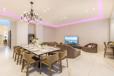 a dining room with a long table and a couch at Bliss Triplex - Hyper Centre - Sauna - BBQ - Jacuzzi - LRACANNES in Cannes