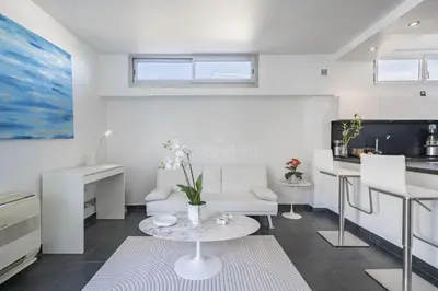 a living room with a table and a kitchen at Rooftop la Croisette in Cannes
