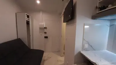 a small room with a white door and a hallway at Winter Palace Beauséjour in Cannes