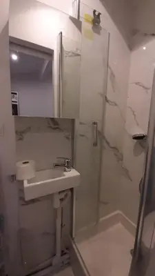 a bathroom with a sink and a shower at Winter Palace Beauséjour in Cannes