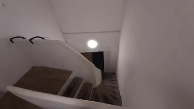 a white staircase in a white room with a light at Winter Palace Beauséjour in Cannes