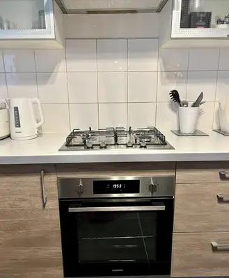 a kitchen with a stove top oven in a kitchen at Maison de charme idéalement située in Cannes