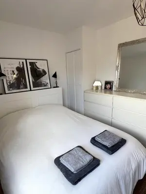 a bedroom with a white bed with two towels on it at Maison de charme idéalement située in Cannes