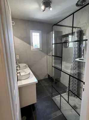 a bathroom with a sink and a glass shower at Maison de charme idéalement située in Cannes