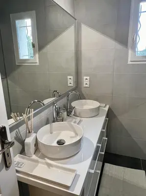 a white bathroom with two sinks and a mirror at Maison de charme idéalement située in Cannes