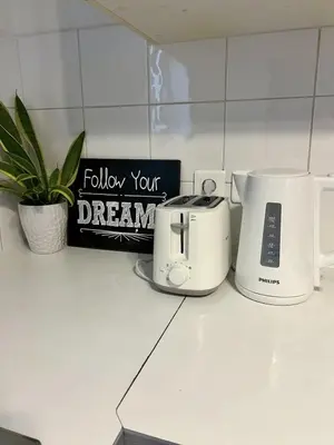 a kitchen counter with a toaster and a coffee maker at Maison de charme idéalement située in Cannes