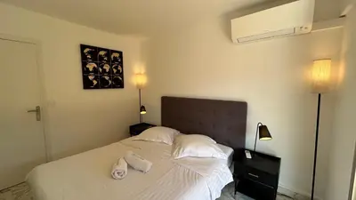 a bedroom with a bed with two towels on it at A083 - Modern & Bright apt - Cannes center in Cannes