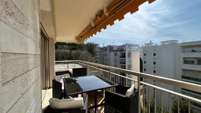 a balcony with a table and chairs on a building at A083 - Modern & Bright apt - Cannes center in Cannes