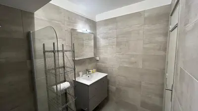 a bathroom with a sink and a mirror at A083 - Modern & Bright apt - Cannes center in Cannes