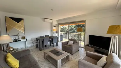 a living room with a couch and a television and a table at A083 - Modern & Bright apt - Cannes center in Cannes