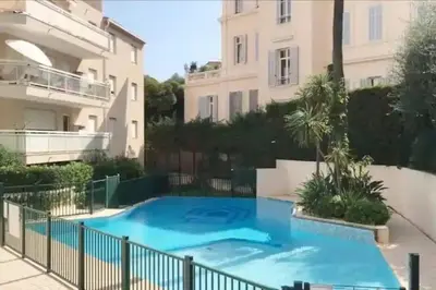 a swimming pool in front of a building at Cannes Résidence Passy avec Piscine in Cannes