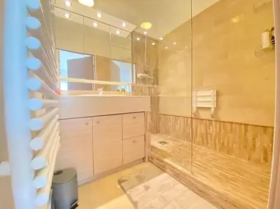 a large bathroom with a shower and a sink at Cannes Résidence Passy avec Piscine in Cannes
